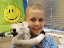 Patient Katie Ridenour smiling with stuffed animal 