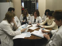 Doctors Reviewing Materials During Rounds